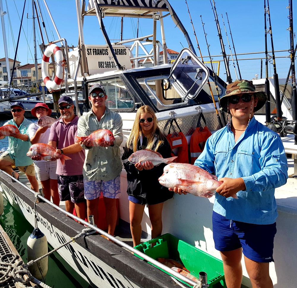 Happy guests with their catch of red roman on a St Francis Safaris boat