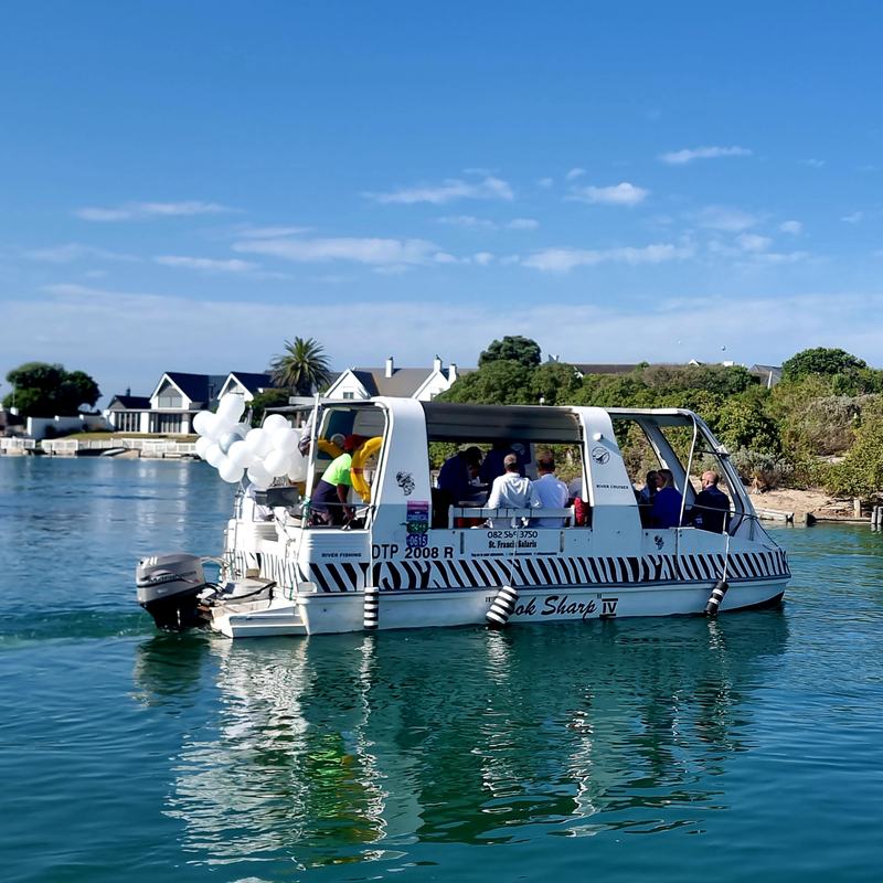 Canal cruise past the white-walled homes of St Francis Bay